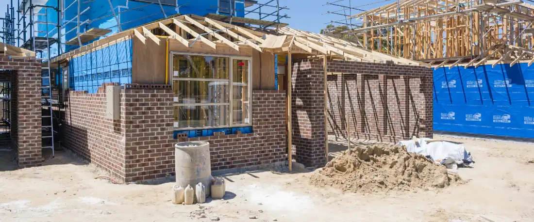 A brick home construction site with masonry walls